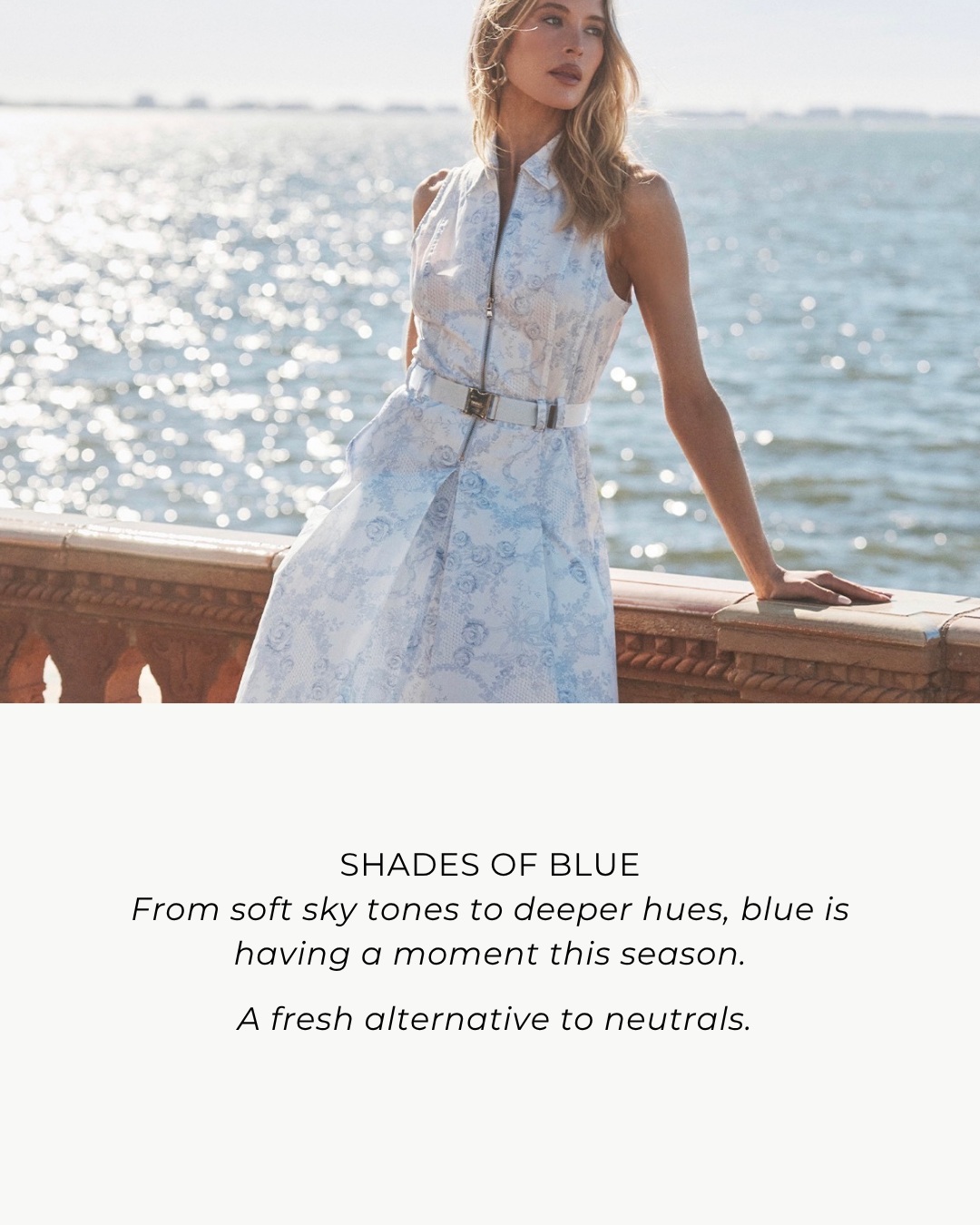 Woman in a light blue floral dress standing by a waterfront with text about blue being a fresh alternative to neutrals.