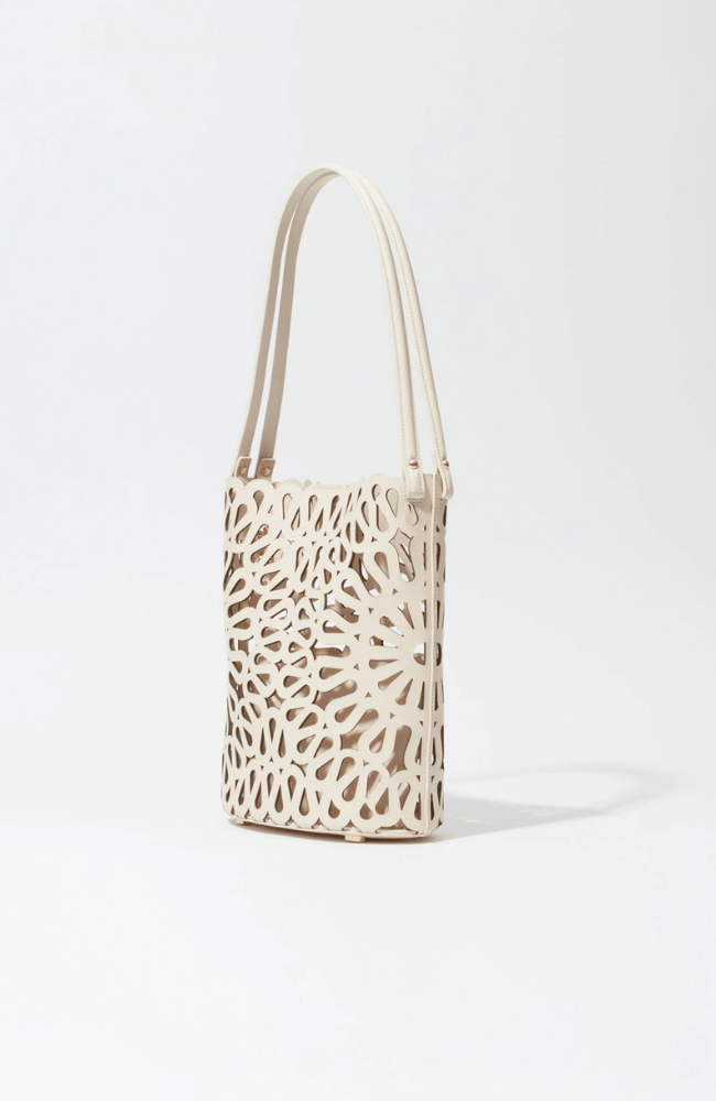 MCCALL LASER CUT LEATHER BUCKET BAG in CREAM-SIMKHAI-FLOW BY NICOLE CANADA