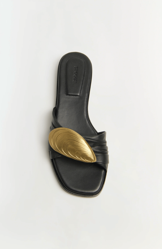 GIGI OYSTER LEATHER FLAT SLIDE in BLACK ANTIQUE GOLD-SIMKHAI-FLOW BY NICOLE CANADA